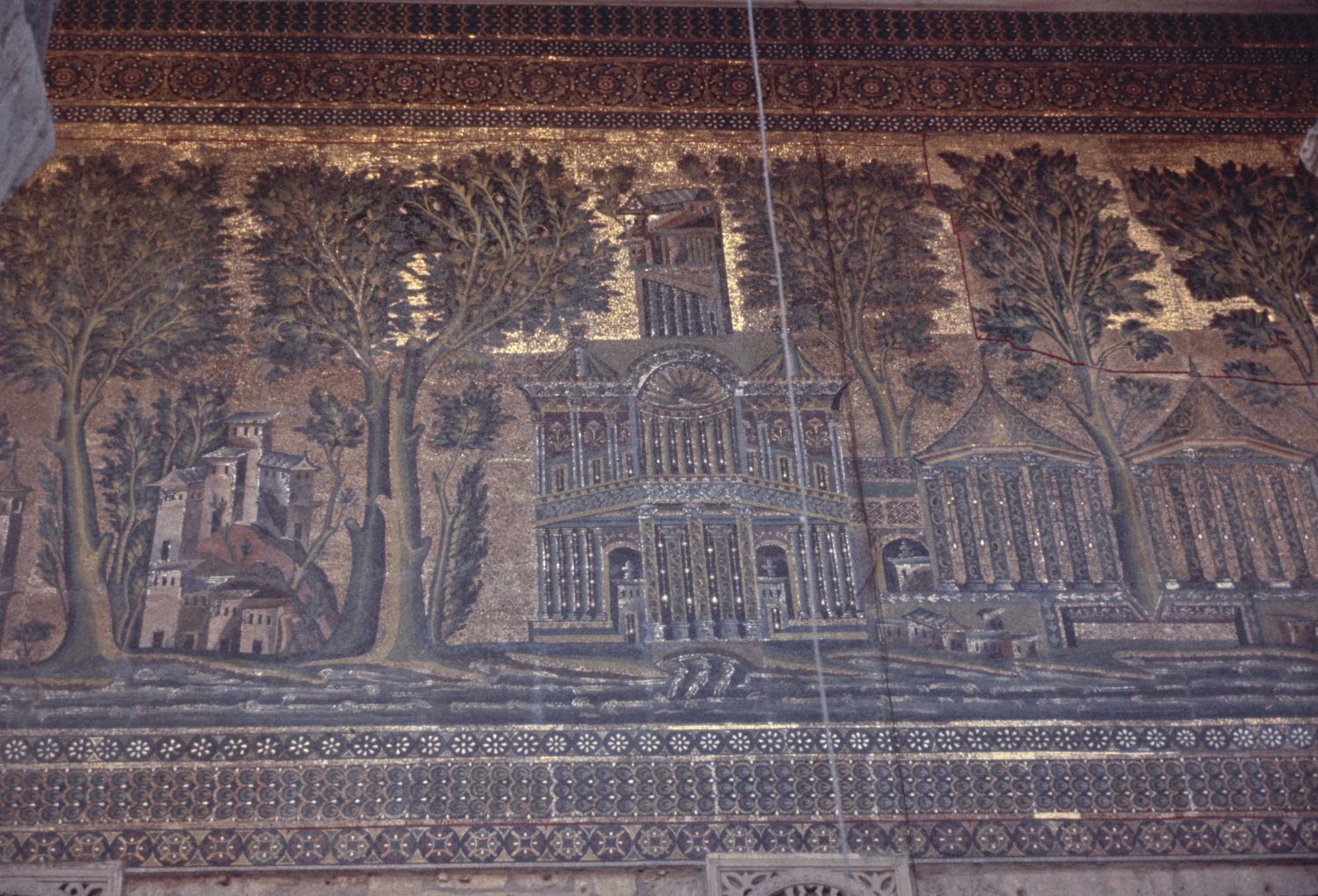 View of mosaics under the arcades surrounding courtyard, showing representations of villas and palatial architecture.