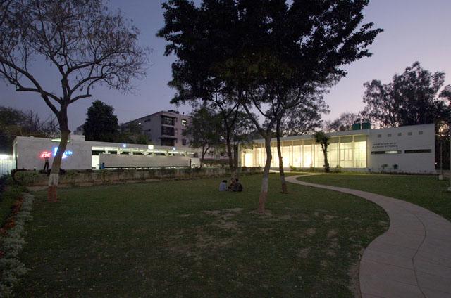 Exterior evening view of cafe and art gallery cultural centre layout