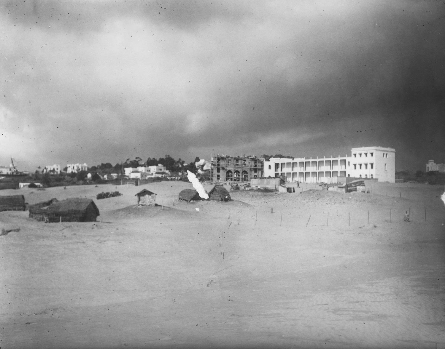 View over the sand toward the school under construction