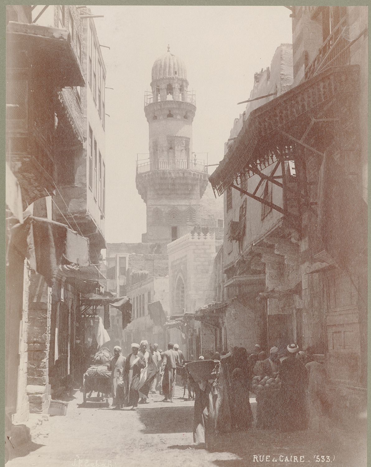 View along busy street toward minaret of Sultan Baybars al-Jashankir's funerary complex.