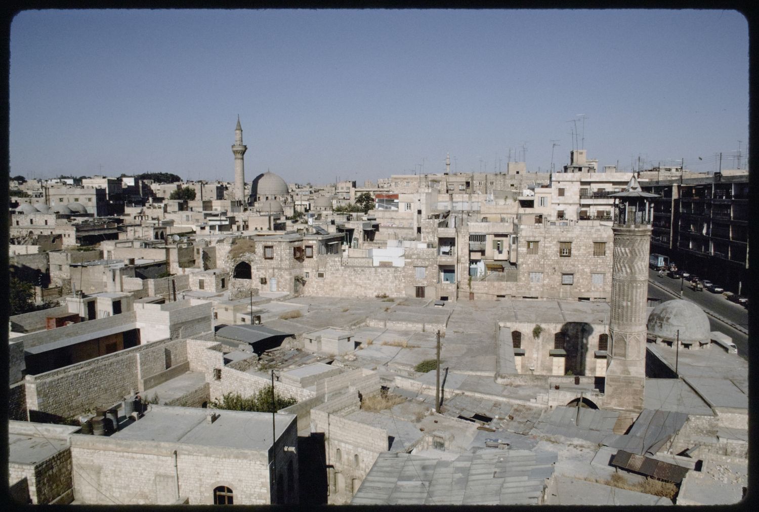 View over urban fabric of old Aleppo along the north side of al-Mutanabbi Street. The minaret of&nbsp;<a href="http://archnet.org/sites/1812" target="_blank" data-bypass="true">Jami' al-Mihmandar</a>&nbsp;is visible in foreground, and the dome and minaret of&nbsp;<a href="http://archnet.org/sites/3546" target="_blank" data-bypass="true">al-Madrasa al-Uthmaniyya</a>&nbsp; in background.