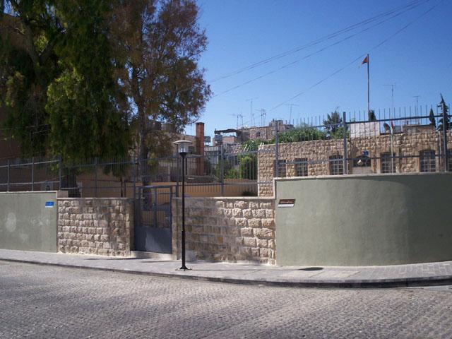 Arwa bint al-Hareth school concrete fence lowered and plastered to enhance the urban street-building interface relation