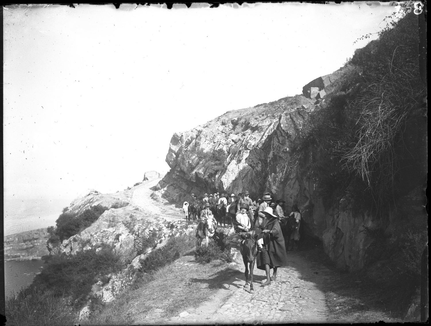 A large group of European tourists on mules on the Agla Path to Cap Spartel