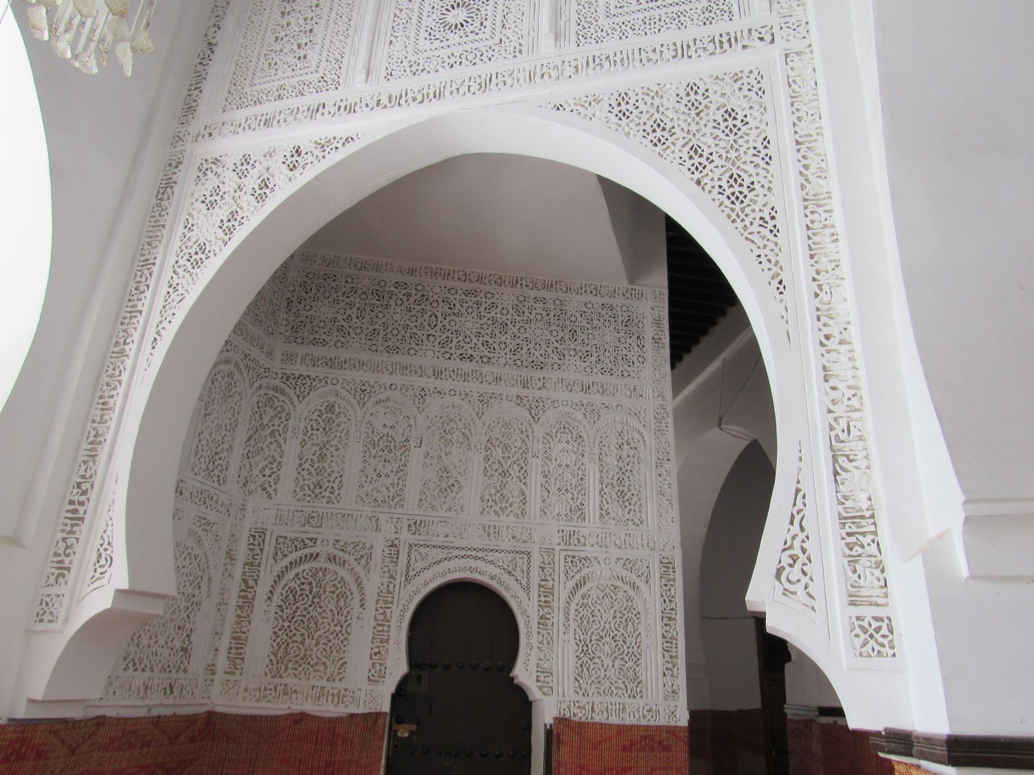 Interior view, hallway decorated with carved stucco, geometric patterns.
