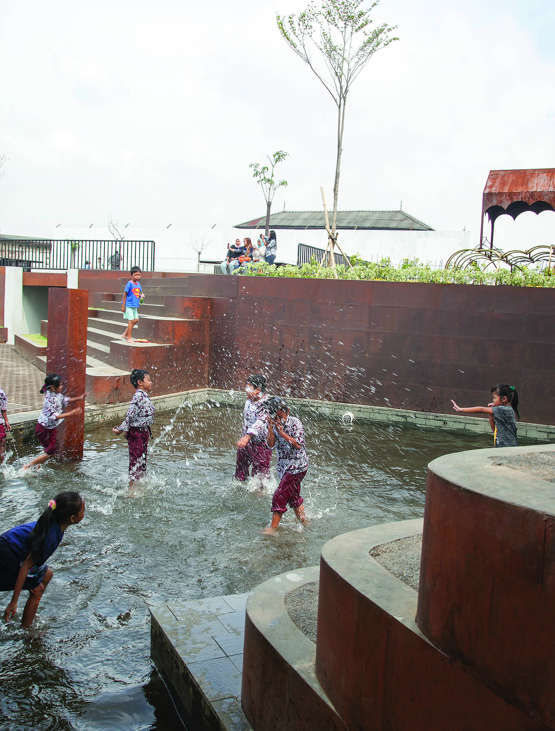 <p>Kids playing with water in the shallow pool</p>