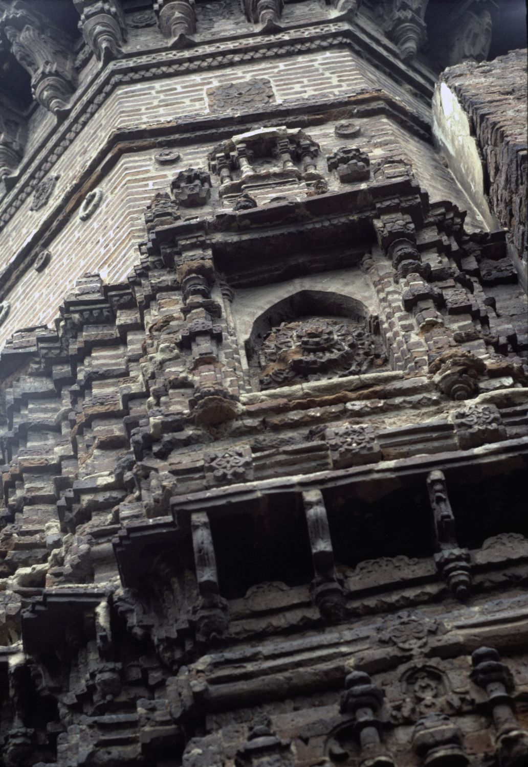 Close view of ornamented section near base with niche.
