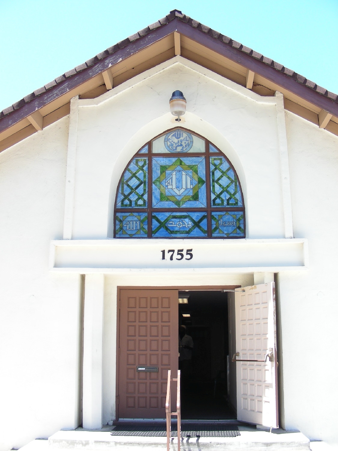 Main entrance, with stained glass window above