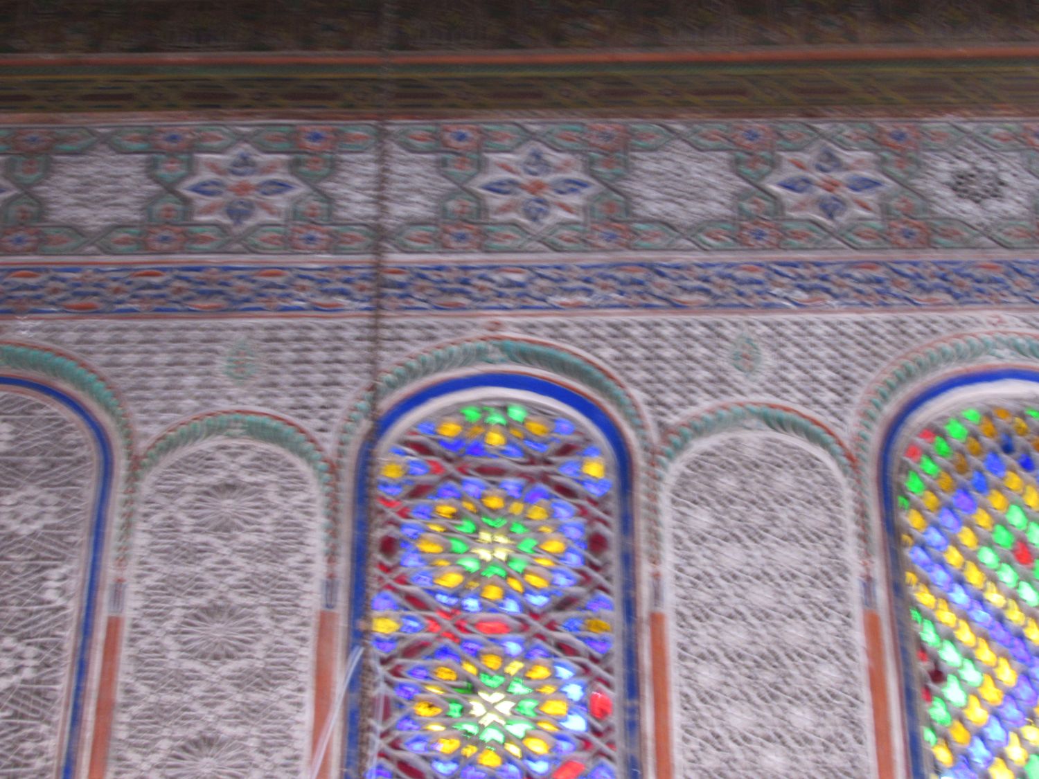 Interior view, prayer hall stain glass windows and carved wall.