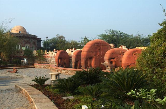 Sandstone elephants with administration office in background
