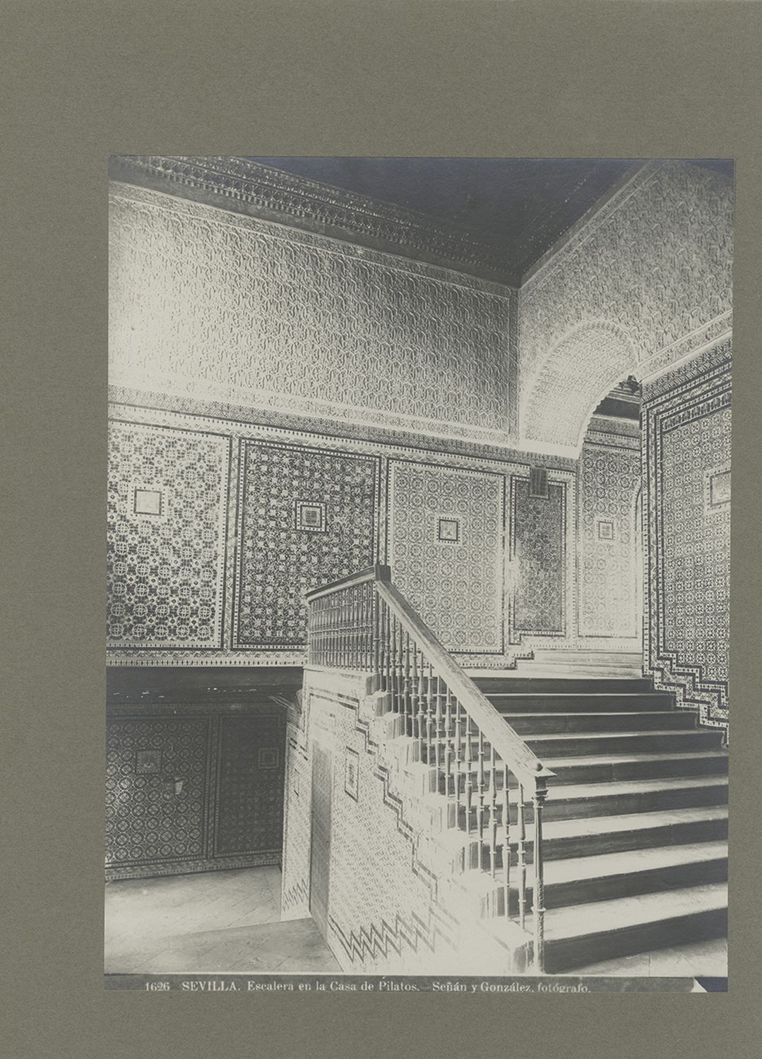 Casa de Pilatos - View of stairway with tilework and carved stucco ornament on walls.
