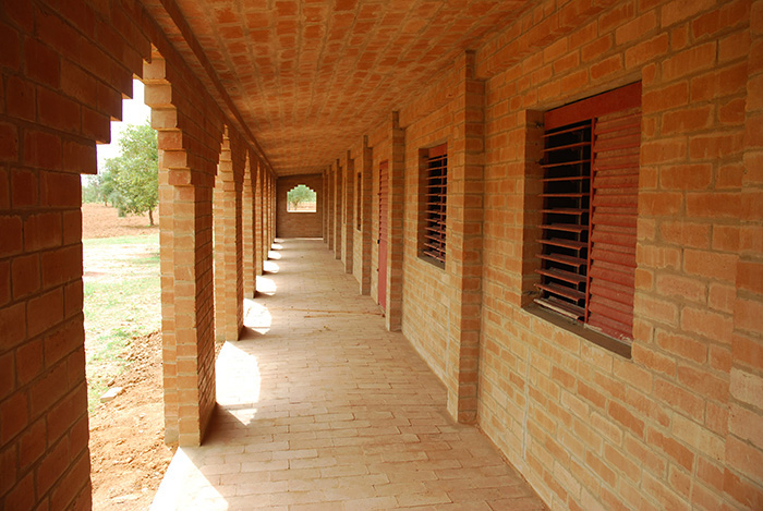 The veranda function as buttresses to catch the load of the barrel vault roof of the classrooms      