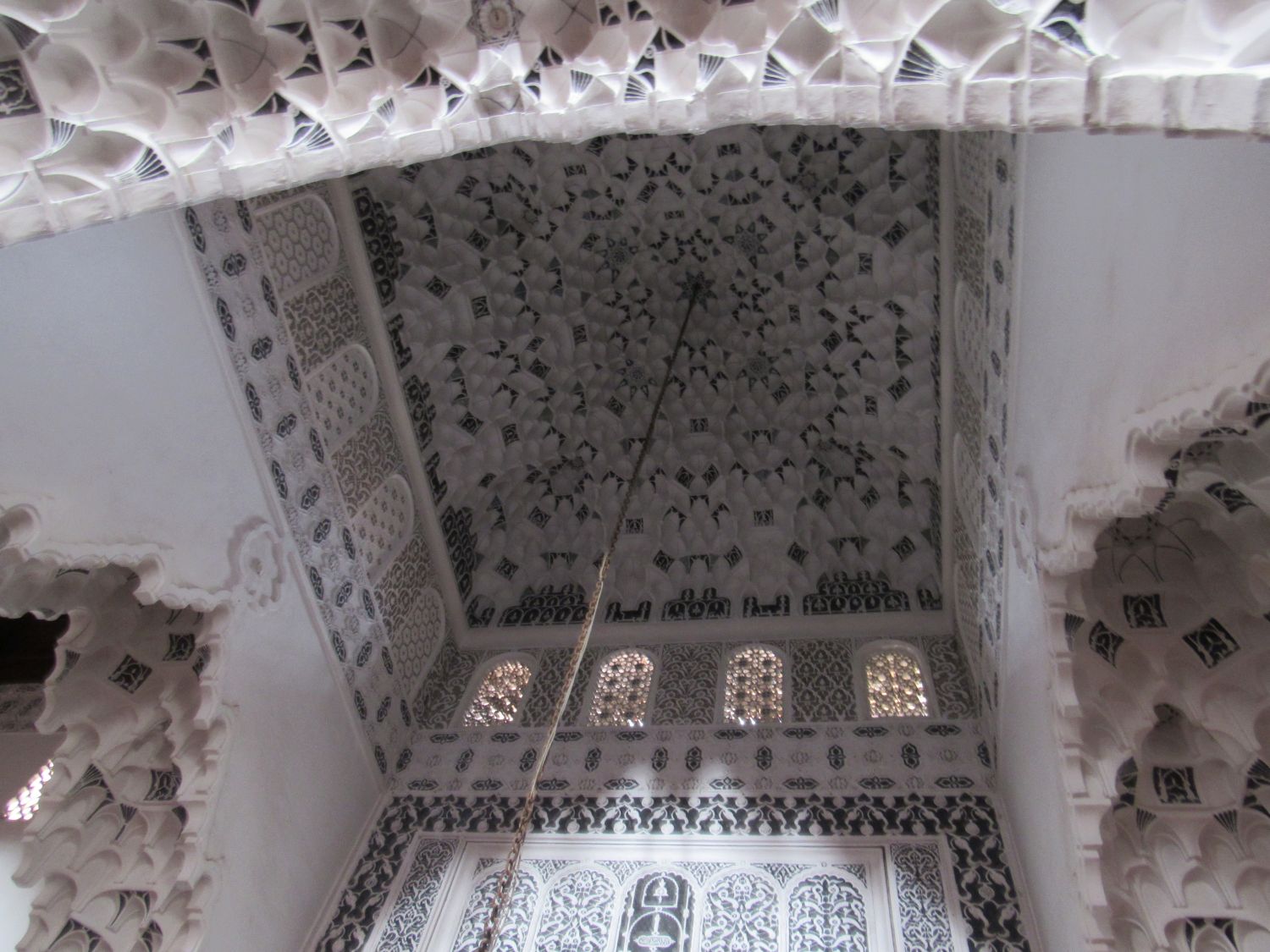 Upward view of the mihrab bay ceiling decorated with black and white muqarnas
