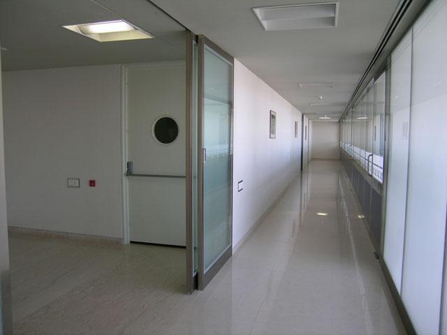 Central corridor with natural light filtering through office areas