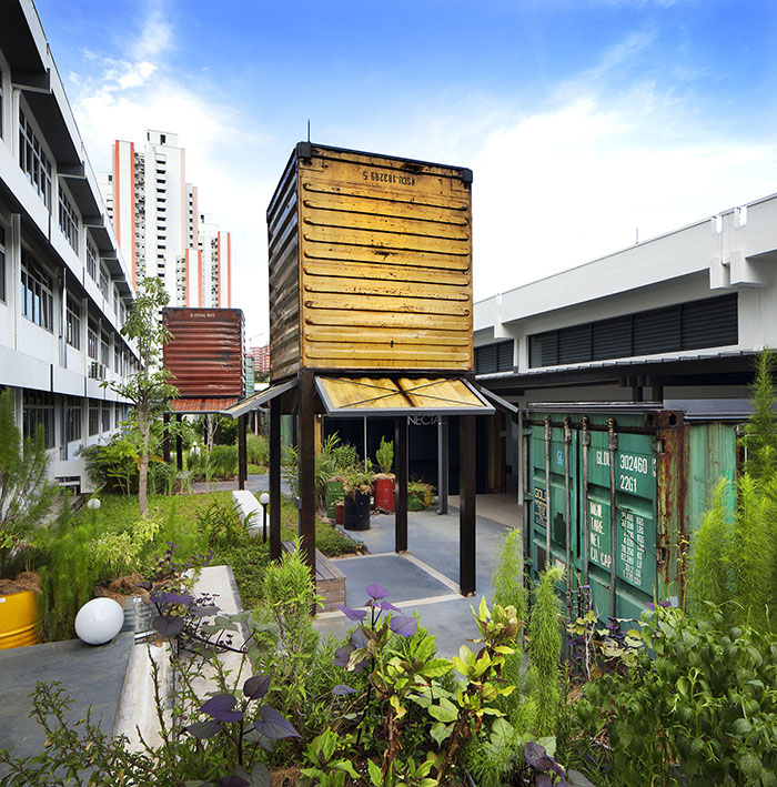 Enabling Village - Re-purposed containers are designed as follies and meeting rooms surrounded by an edible garden and planters in recycled oil drums.<br>
