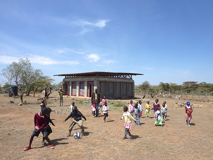 Children playing outside of first built classroom 