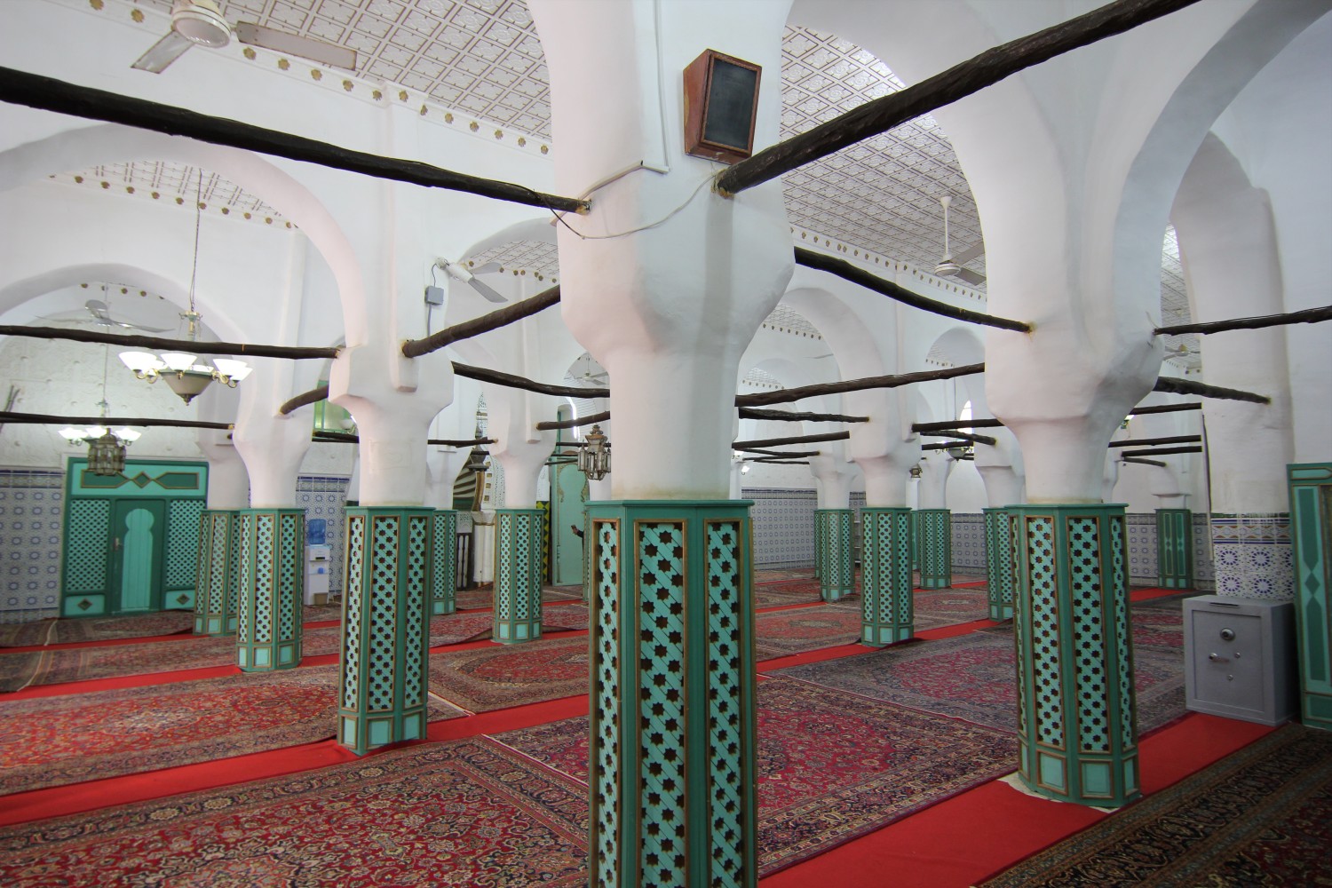View of the prayer hall showing horseshoe arches maintained by wooden rods