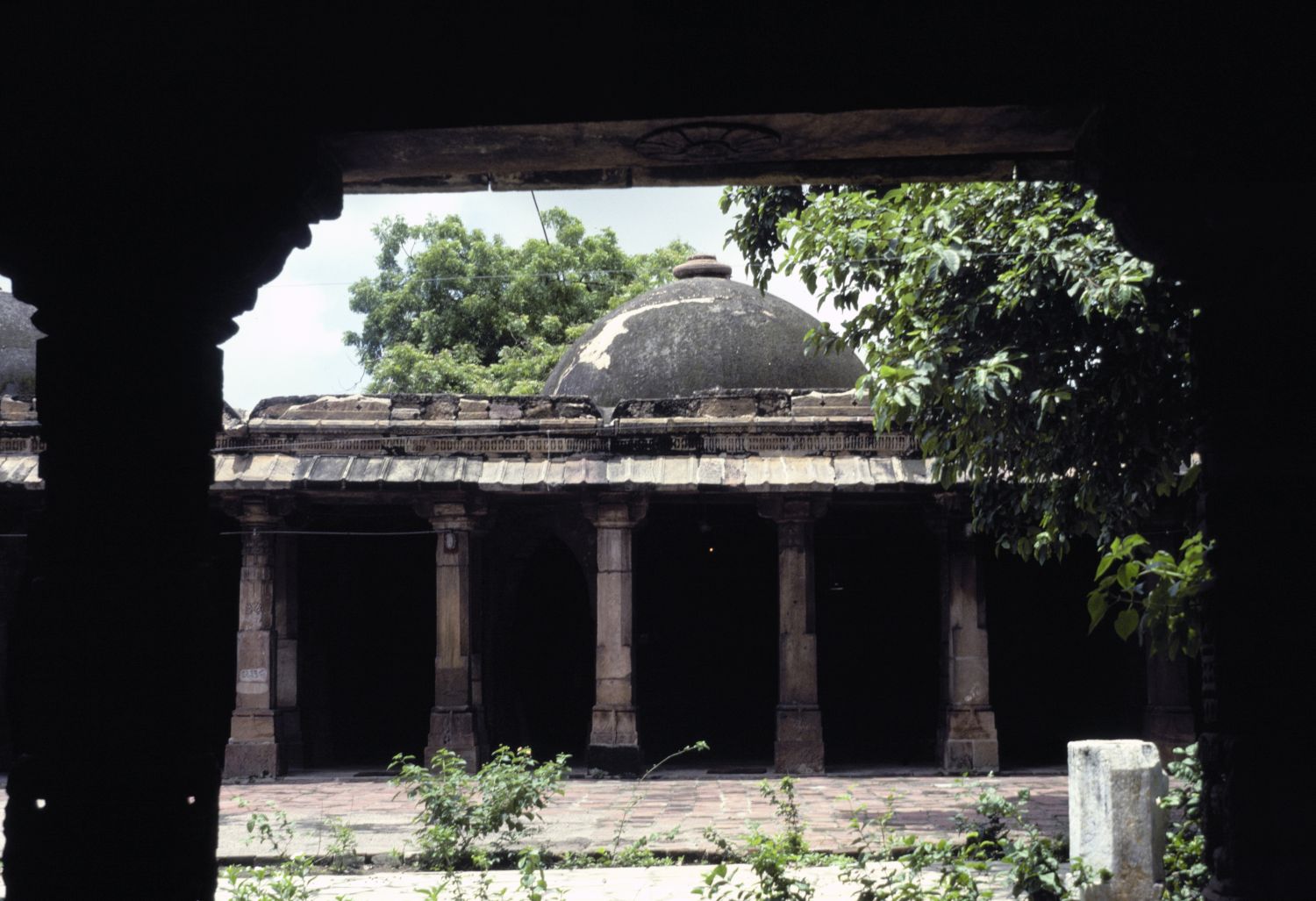 View of east facade from under tomb.