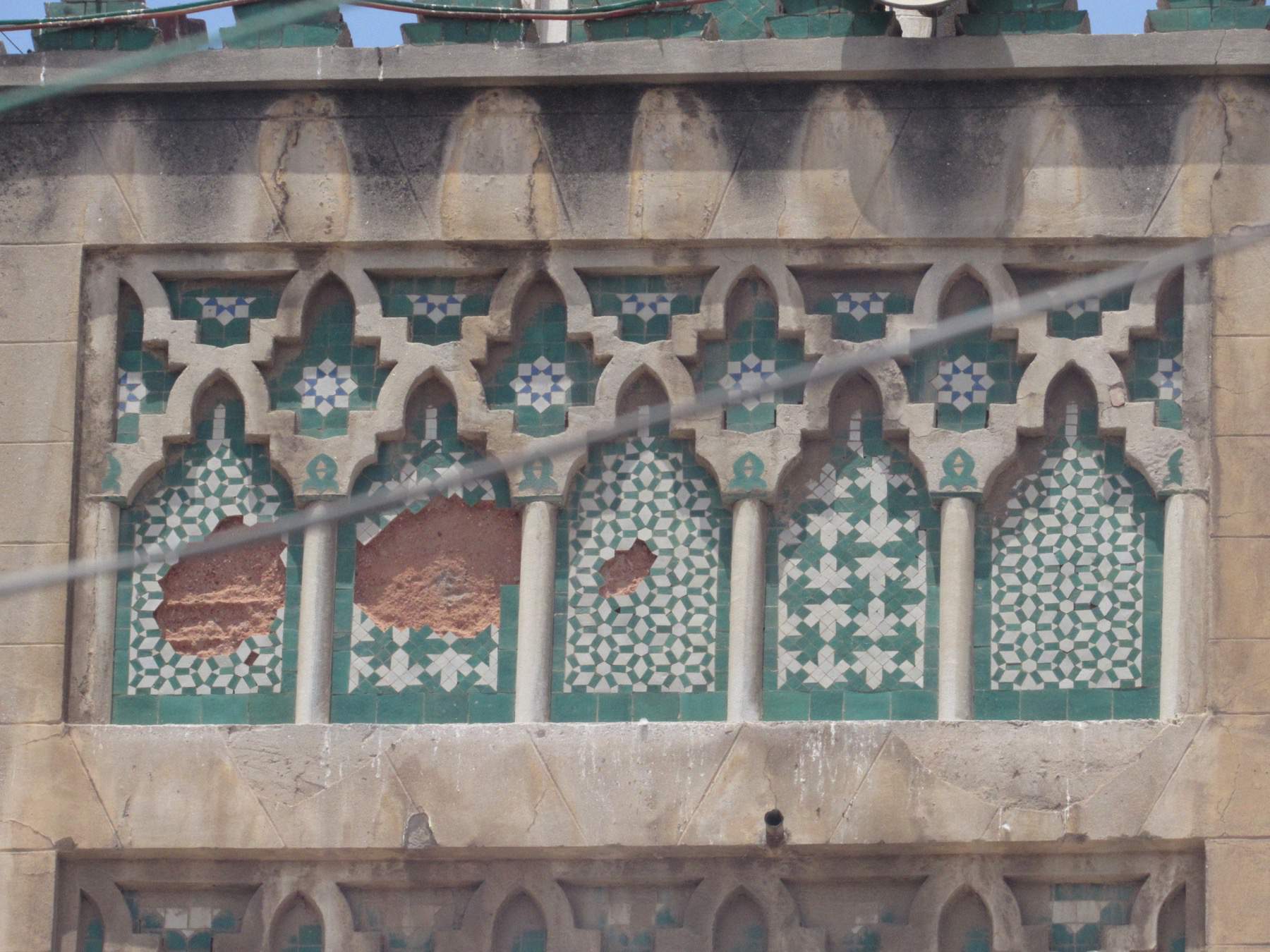 Detail view of stone carving and tile inlay on the minaret