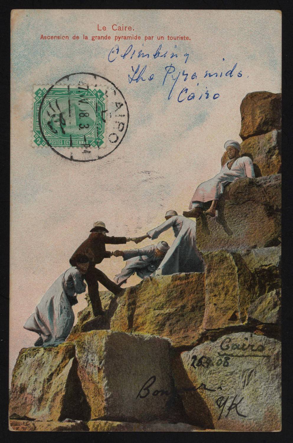 Postcard of men helping a tourist climb the Great Pyramid, Cairo