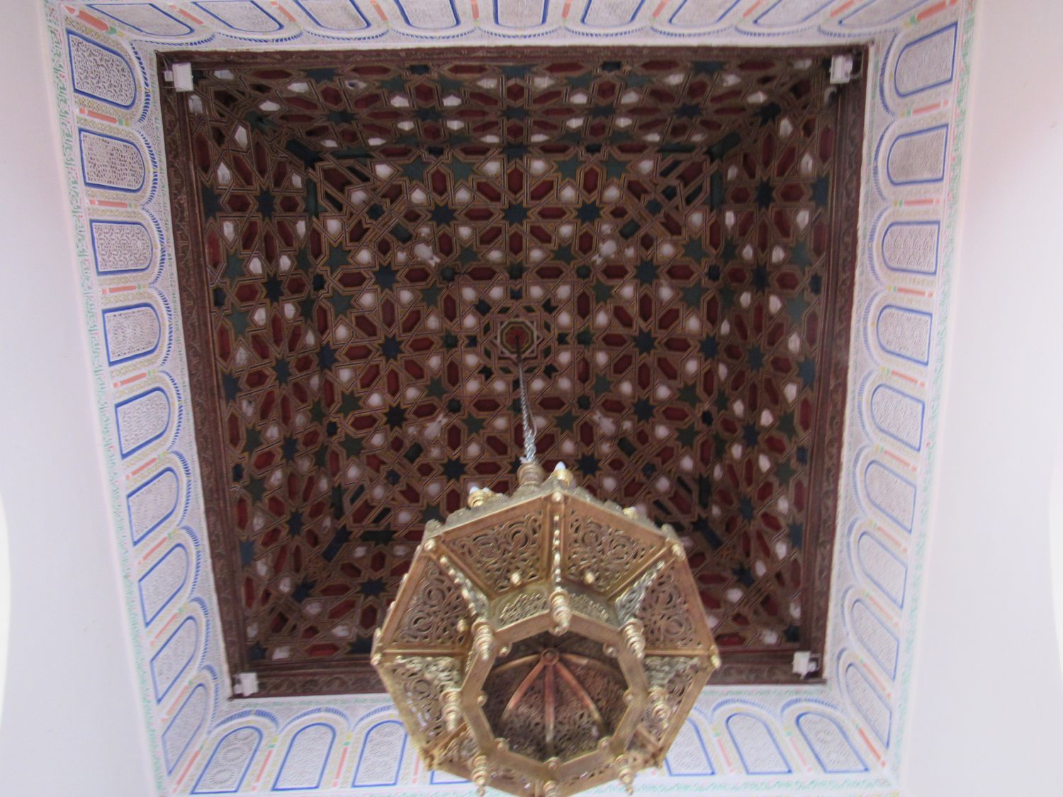 Bab Guissa Mosque and Madrasa - Interior view, mihrab bay wooden ceiling and chandelier.