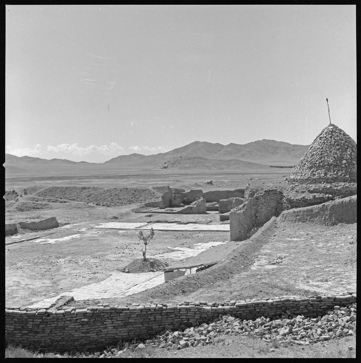 Qasr-i Mas'ud-i Sivvum - View over courtyard from northwest corner facing southeast. Tepe Sardar is visible in background.
