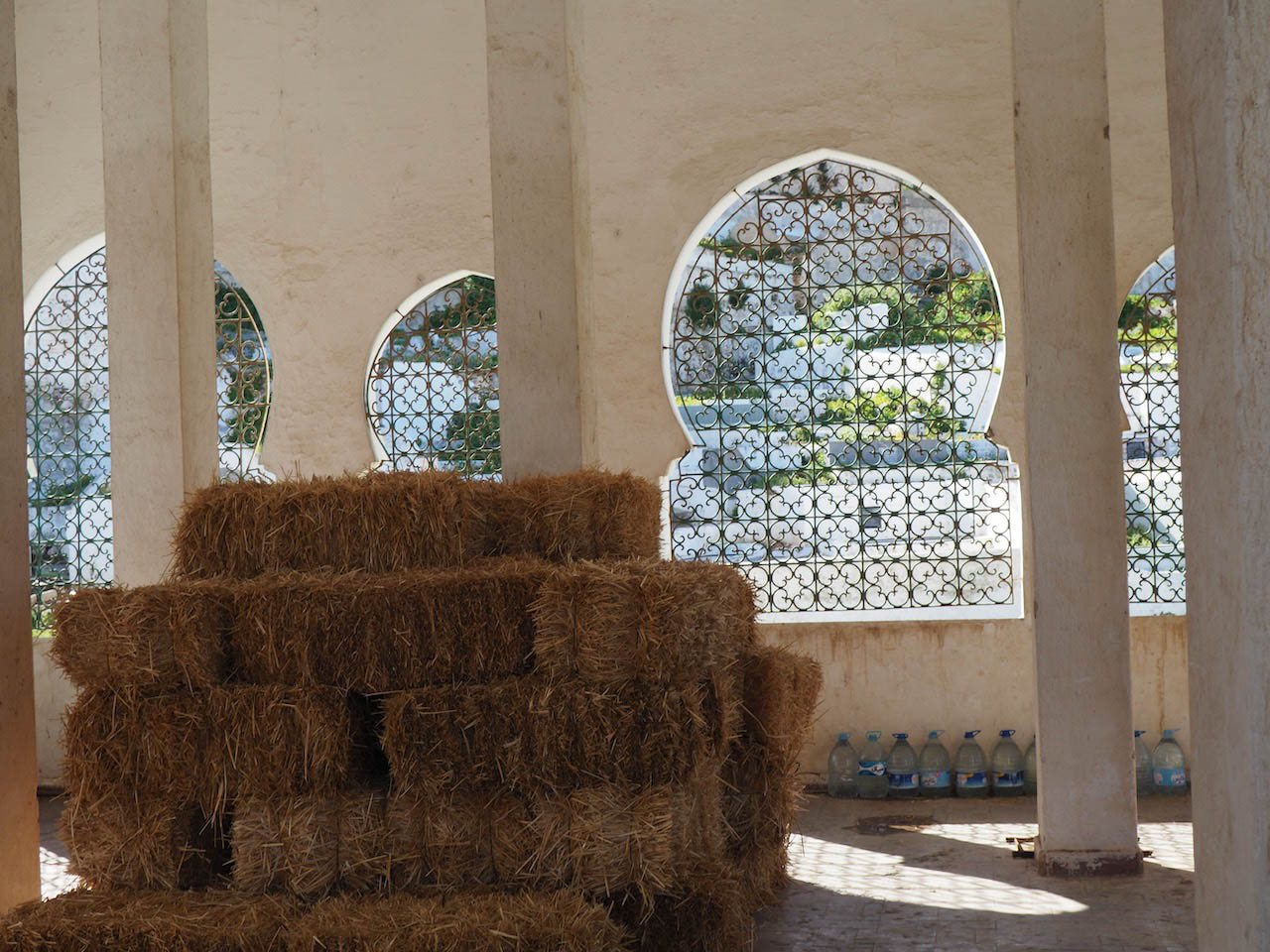 <p>Interior view of the Sidi Al-Mandri Mausoleum with hay bales</p>