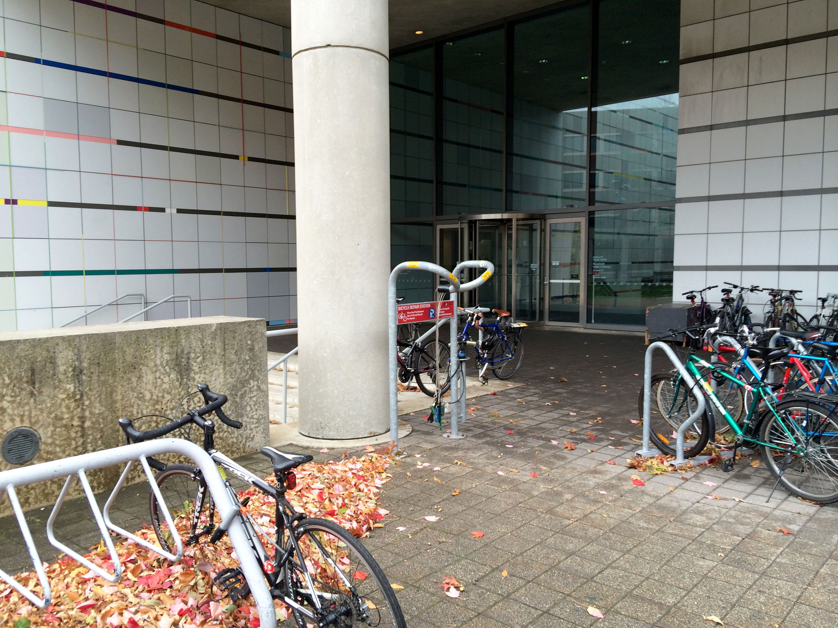 <p>View of the East entrance from the East campus, showing bicycles and bicycle repair station</p>
