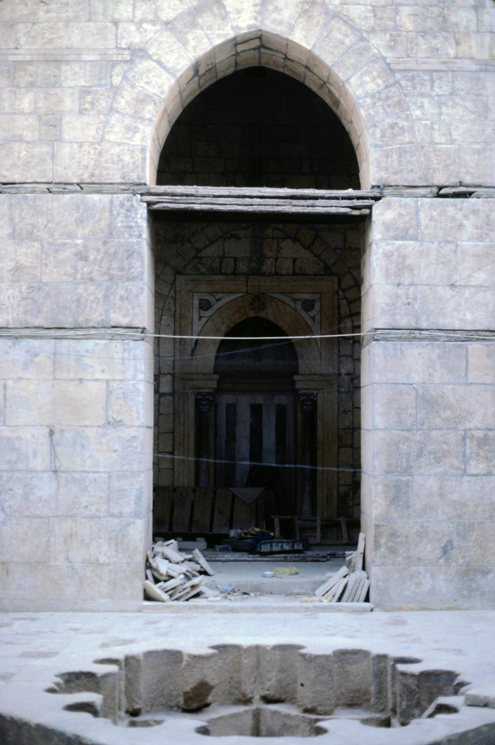 View from the courtyard through an archway towards the mihrab