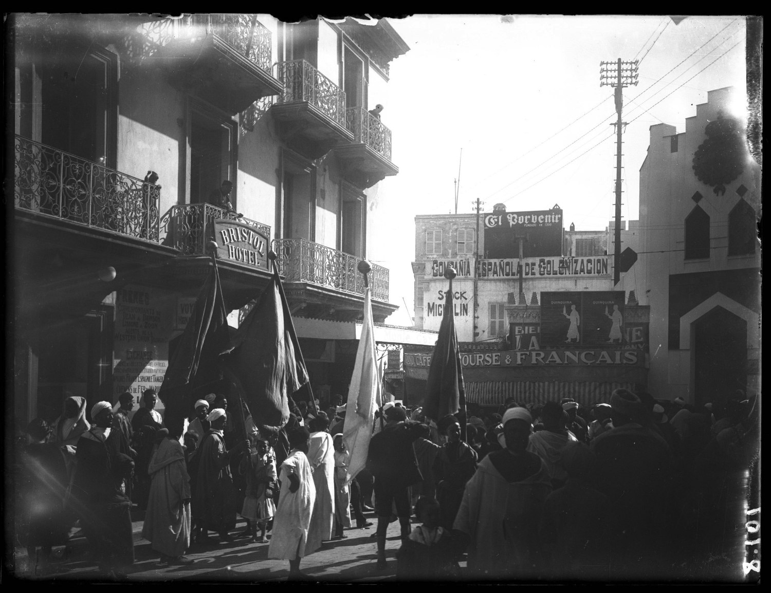 Street scene near Hotel Bristol, Tangier; crowd in Moroccan dress