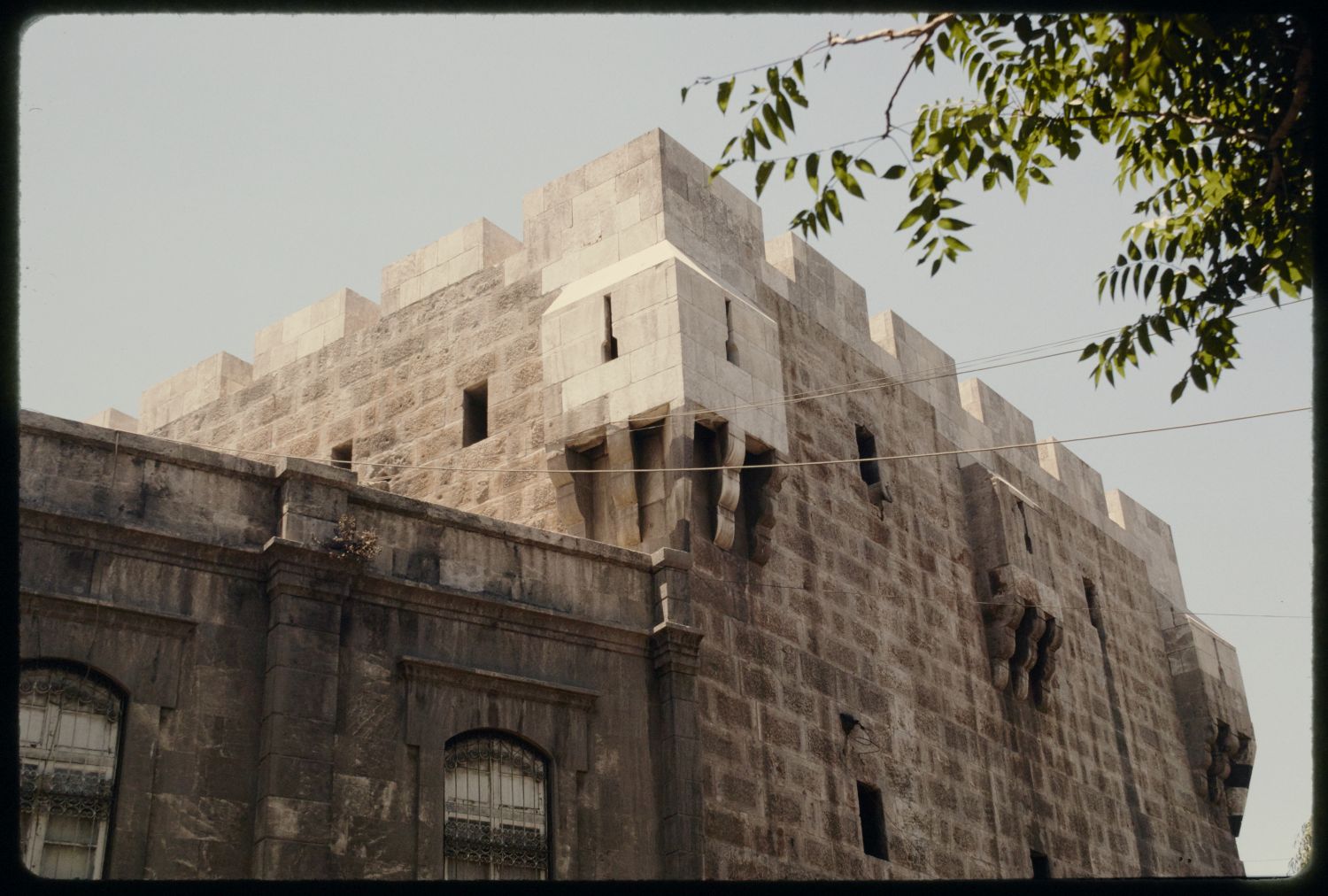 Bab al-Hadid - View of tower with projecting arrow-slit windows on corner.