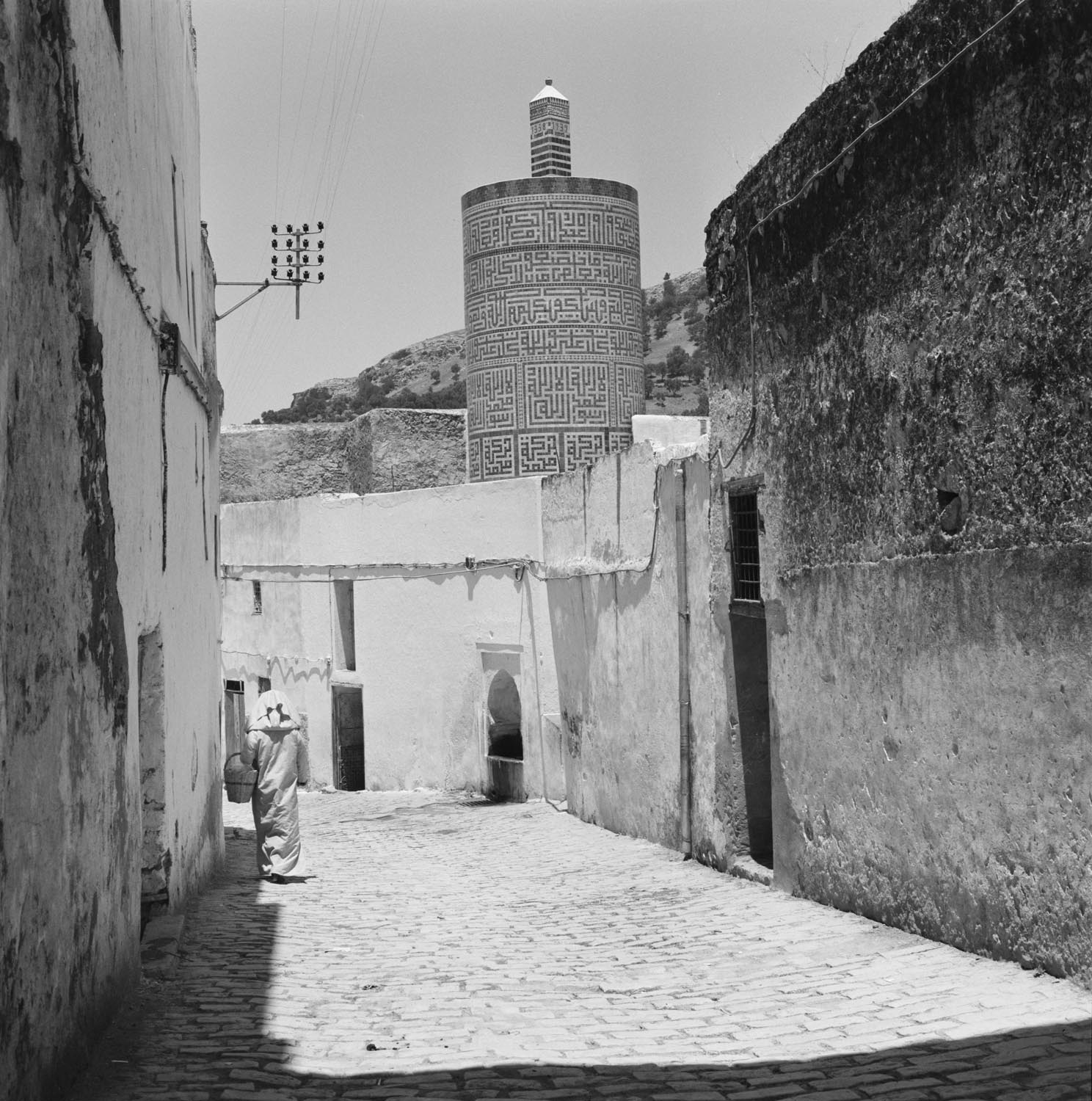 Street view toward the Mosque of Moulay Idris with its circular minaret