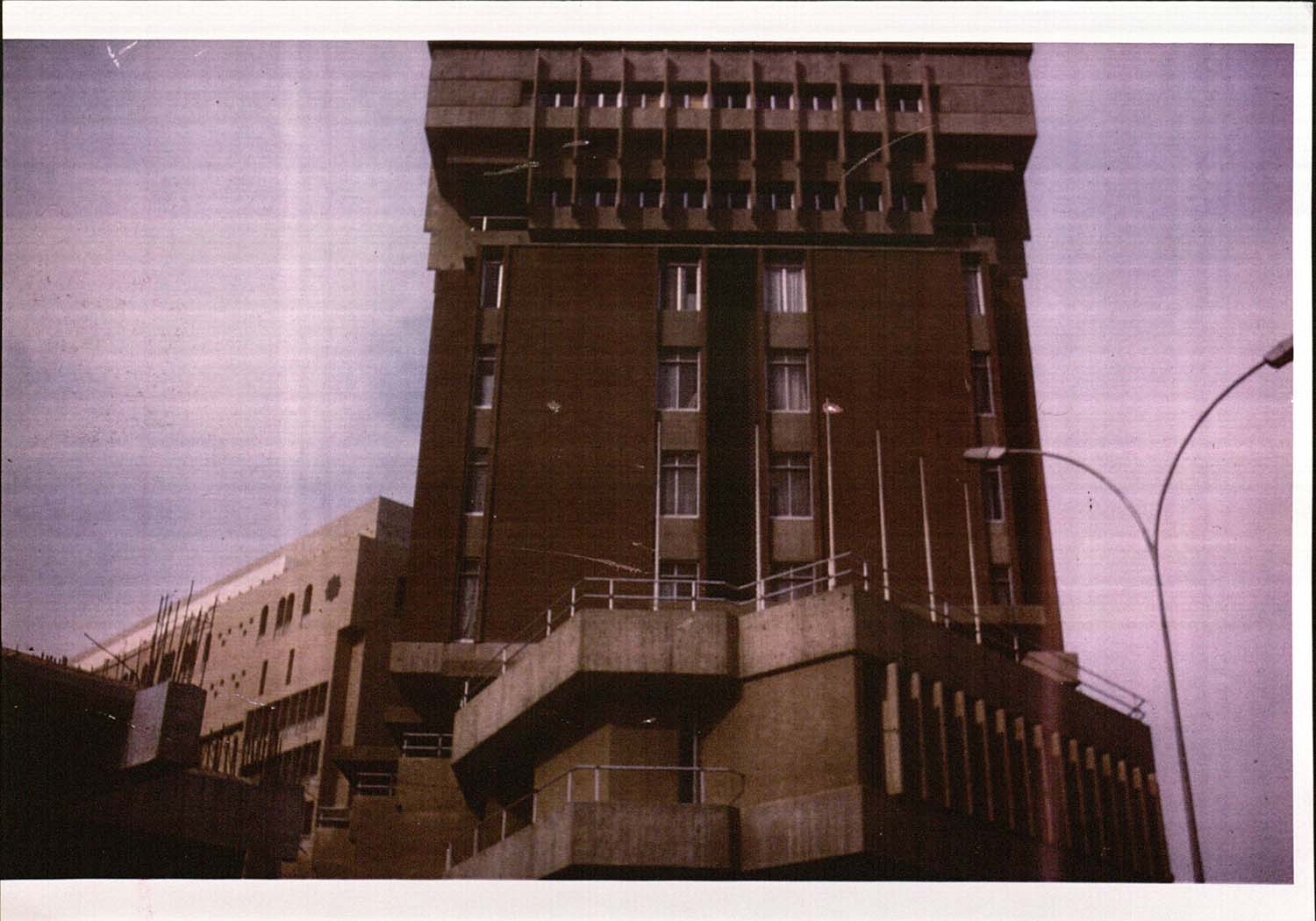 Exterior view of the 1965 Iraqi Reinsurance Building highlighting the hierarchical design of the upper floors.