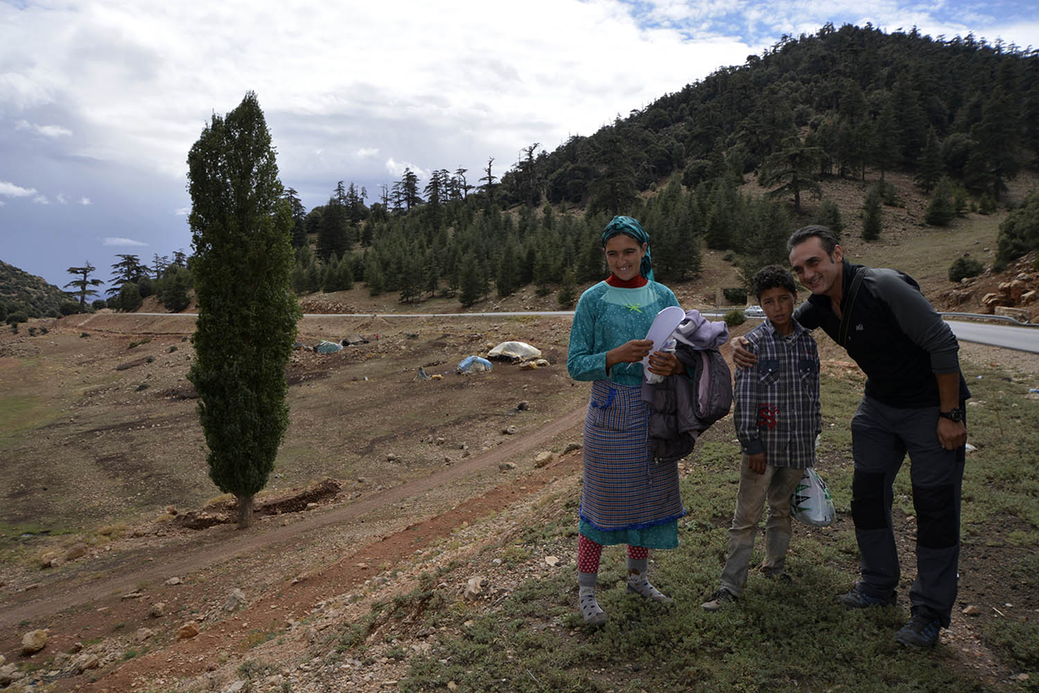 "Cheikha family with a Spanish visitor, and the family's woven wool tents in the background."