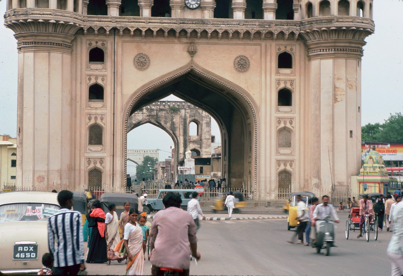 View from south to base of Char Minar showing arches, one arch of Char Kaman visible in distance