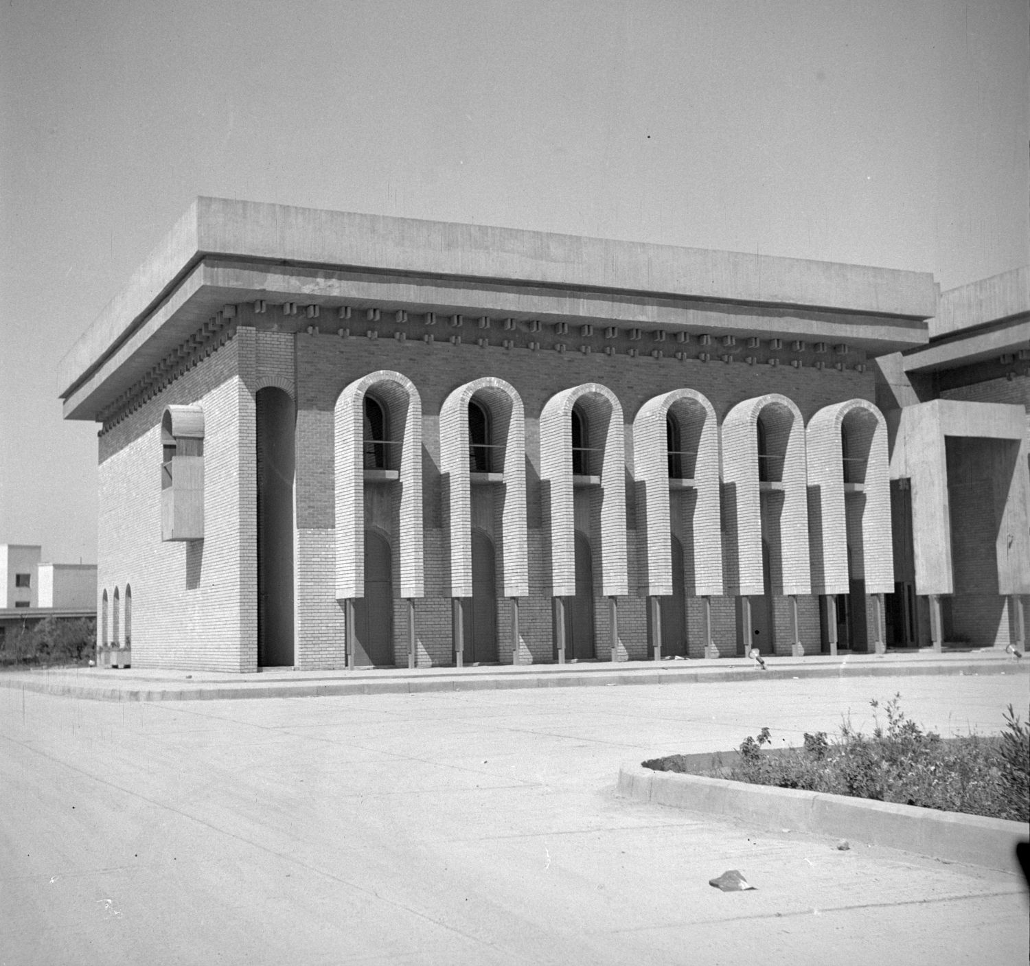 Iraqi Scientific Academy Building - <p>Exterior view, northeast facade, south side, with windows framed by archways.</p>