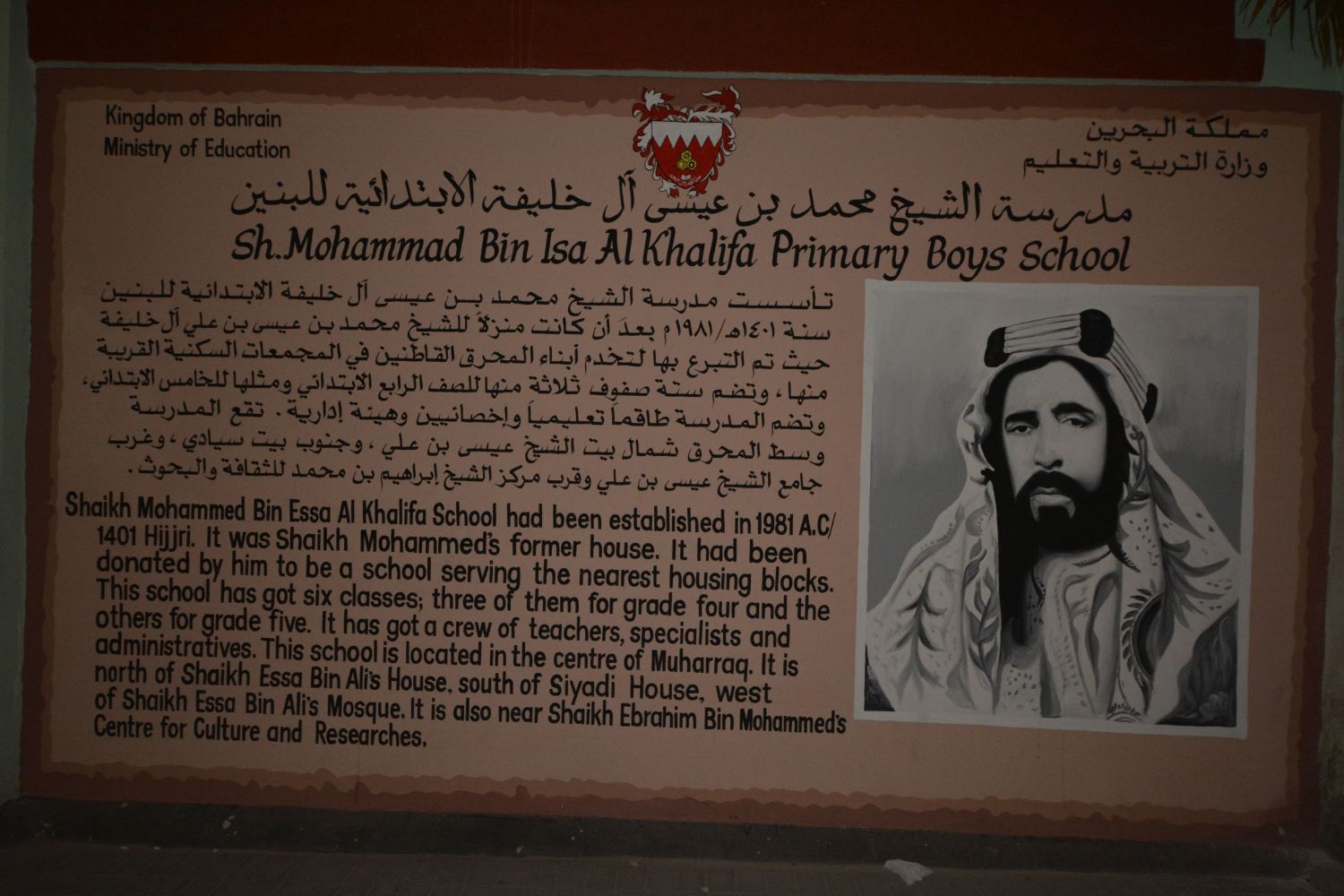 Signage from the Sh. Mohammad Bin Isa Al Khalifa Primary Boys School in Bahrain, giving a historical overview of the building's history in English and Arabic.
