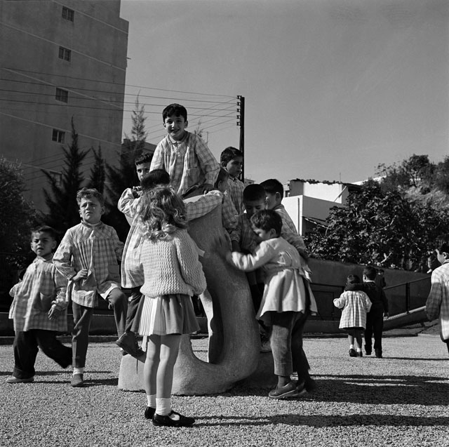 Children playing on Basbous sculpture