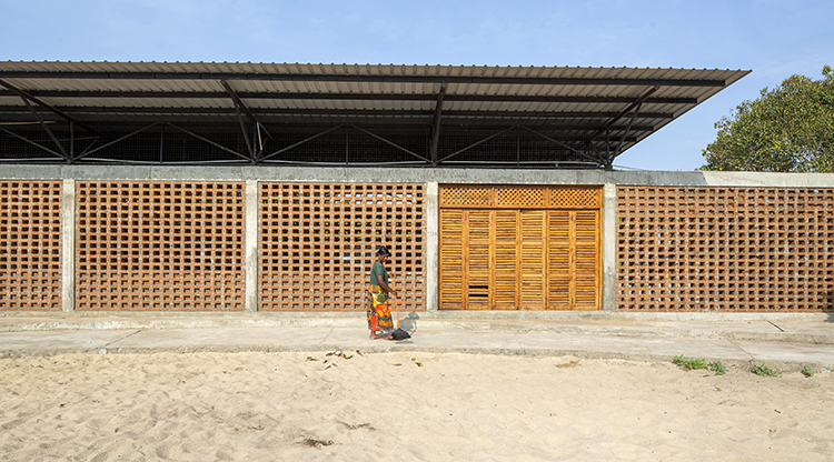 <p>Perforated walls made of locally handcrafted clay bricks as well as the lifted cantilevered roofs permits effective passive cooling and allows the building to be used during the scorching summer months.</p>