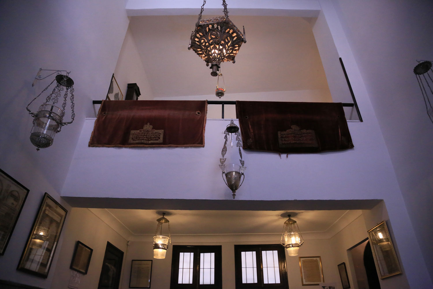 View toward the second floor balcony showing lamps