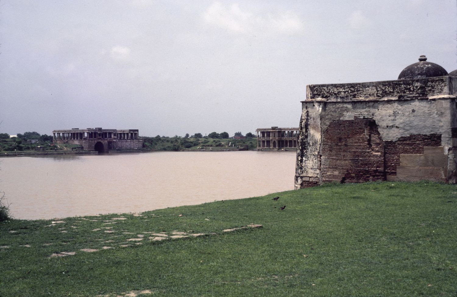 View across tank from northeastern corner toward palaces of Mahmud Shah on south and west banks.