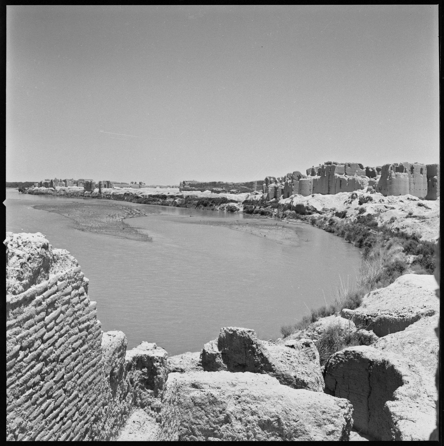 View from South Palace looking towards North along Helmand River. The ruins of the Central Palace are visible at right, and the North Palace is barely visible in background.