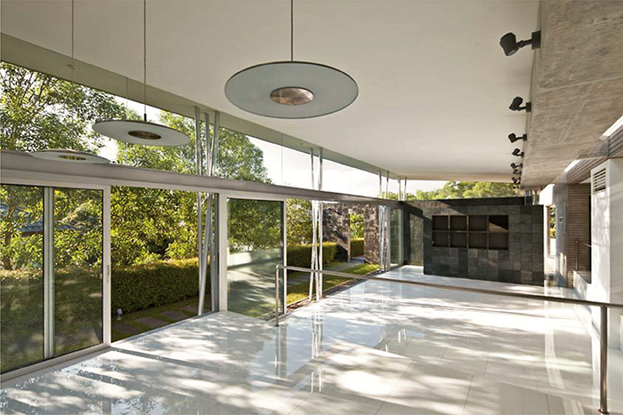 Internal view of the landscape wall as seen from living and dining with designed landscape surroundings 