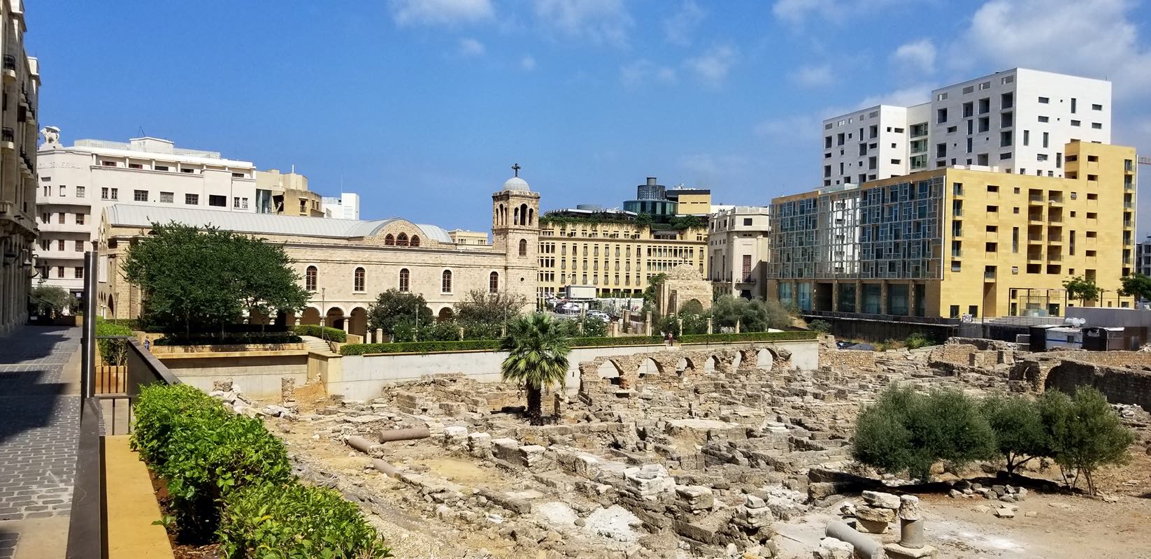 View over Roman archaeological site, with St. George Greek Orthodox Cathedral in background.