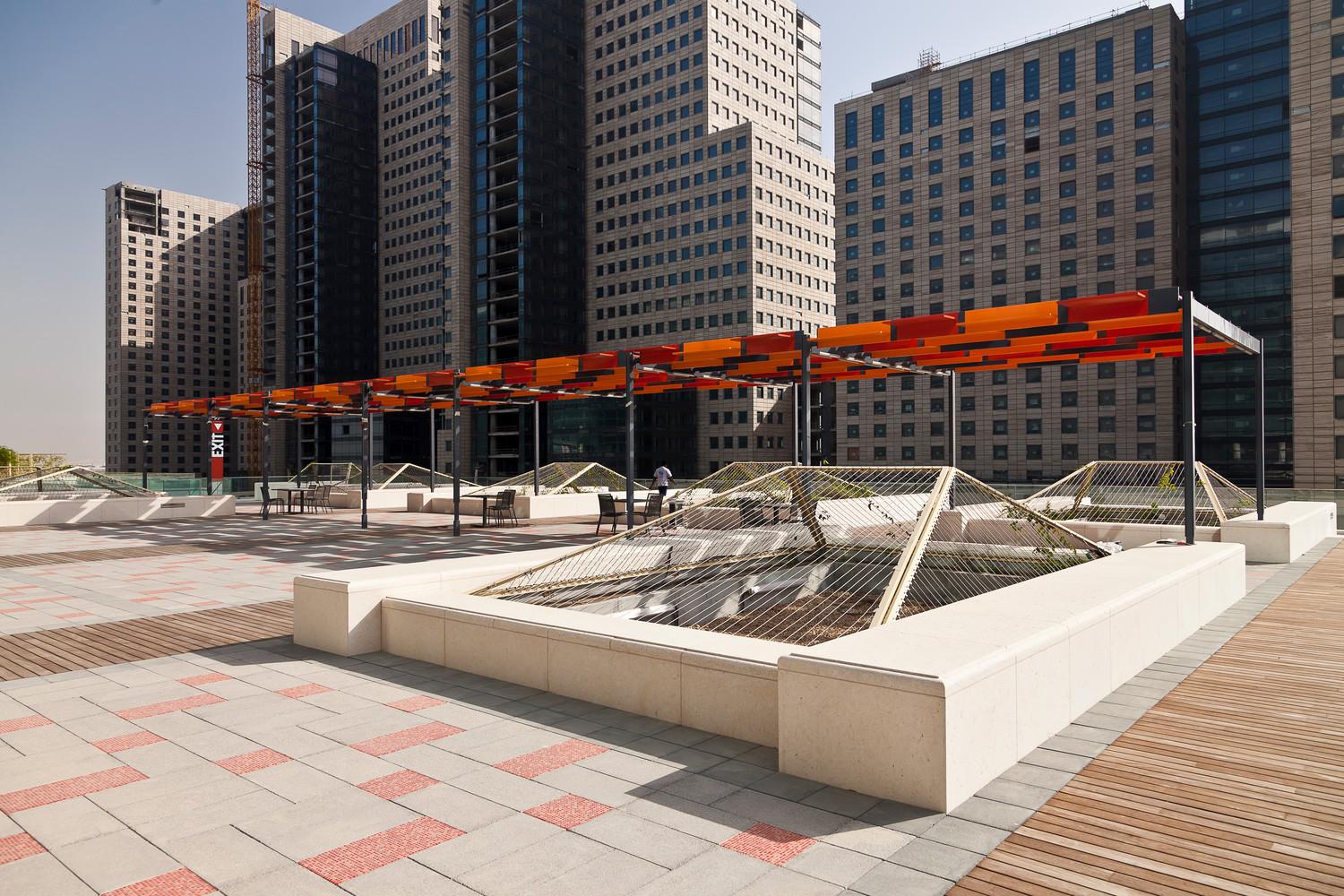 Rooftop Garden shade structure with mixed-use buildings in the back