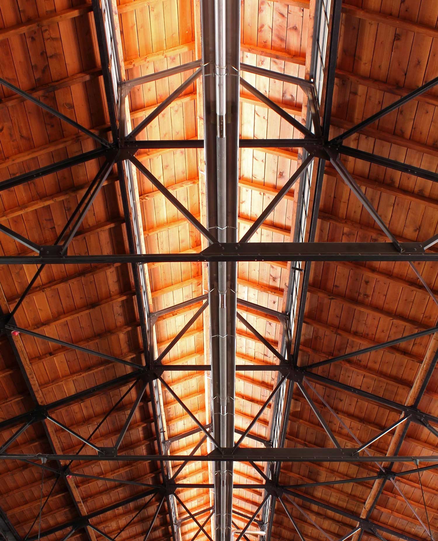 Detail of wooden ceiling construction with steel beams and skylights above the central exhibition space within the Turkish Mechanical and Chemical Cooperation Industry and Technology Museum. 