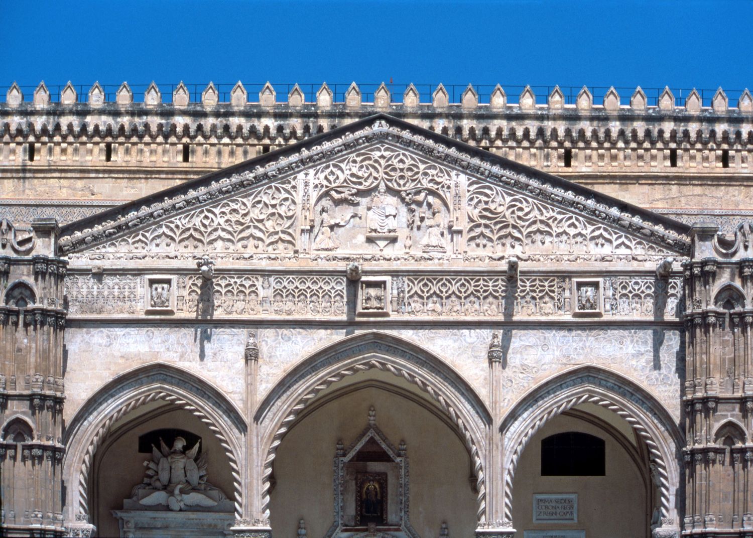 View of top of main portal, showing decorated pediment.