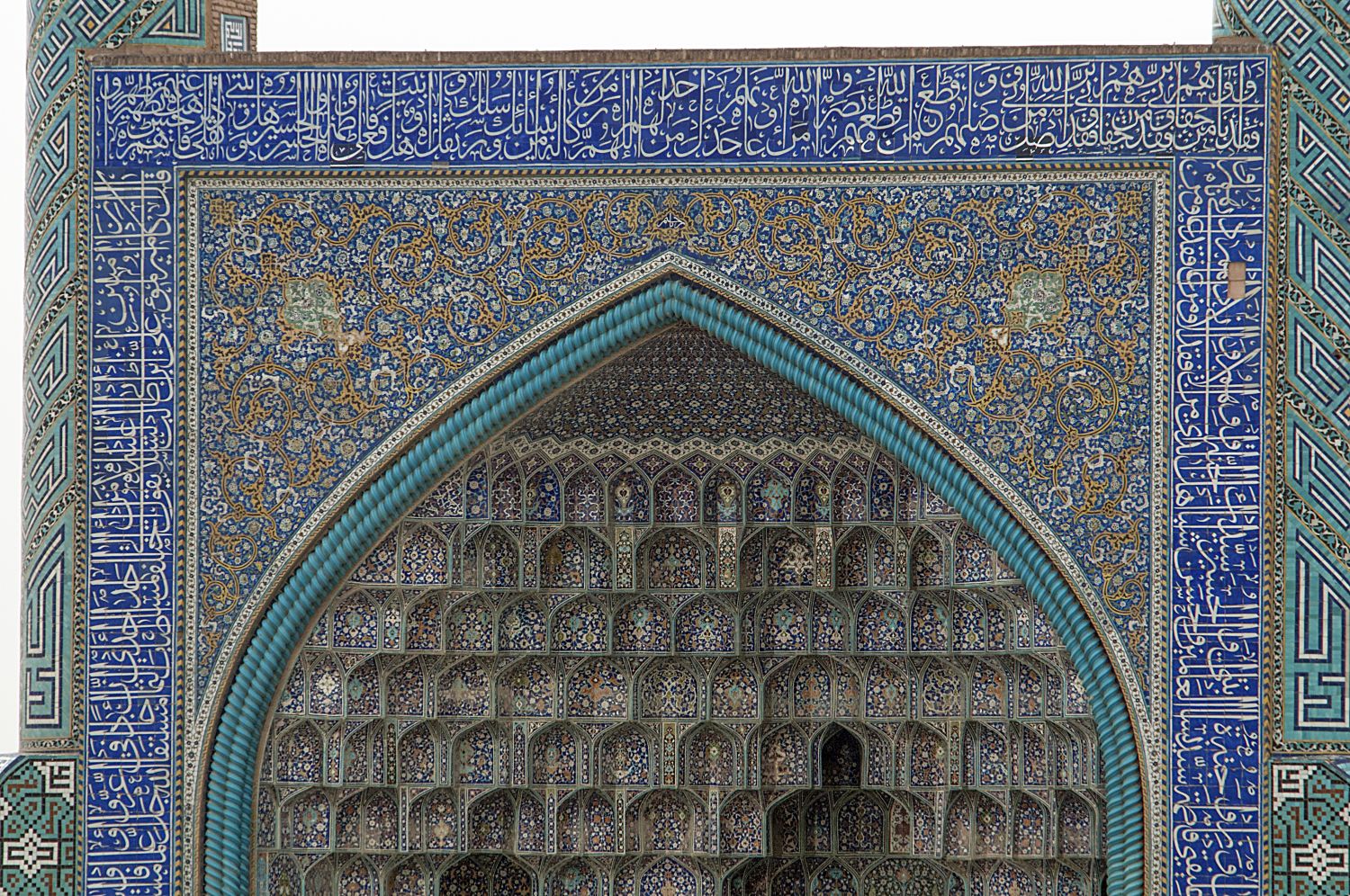 View of facade and vault of entrance portal, showing tilework and muqarnas decoration.