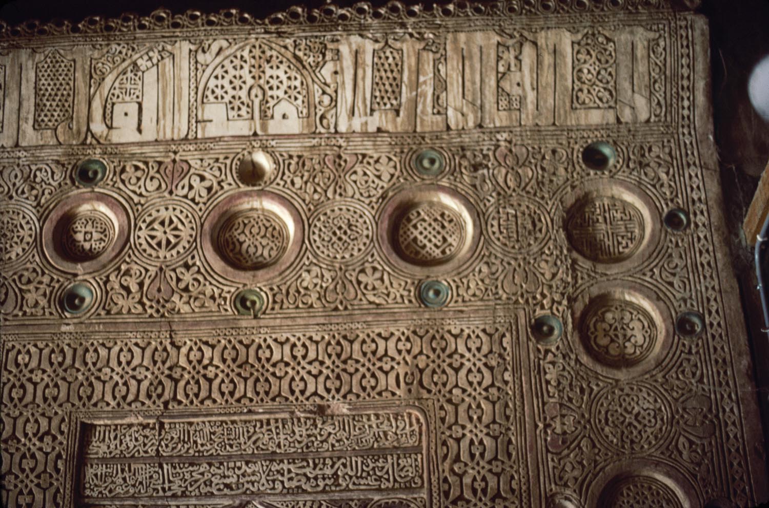 Detail of mihrab showing carved stucco work and inscription.