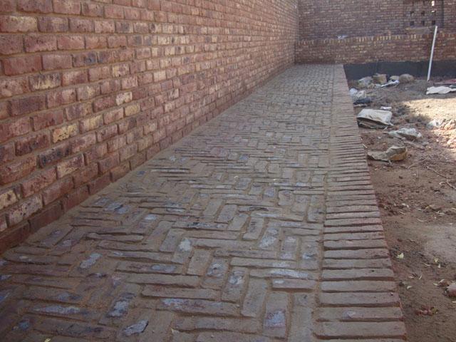 Tiling of east garden path with red bricks
