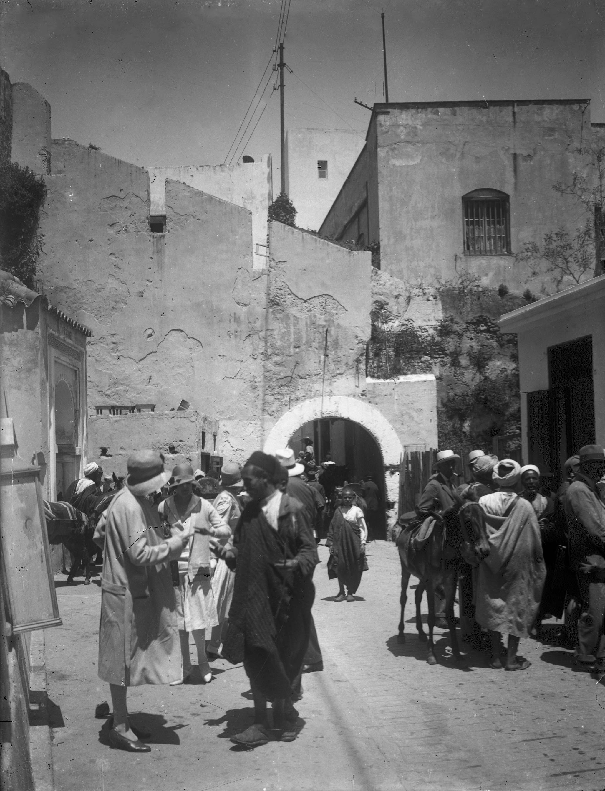 Moroccans and Europeans outside a city gate